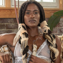 Load image into Gallery viewer, woman with braids using sage causing smoke looking at peace in a room